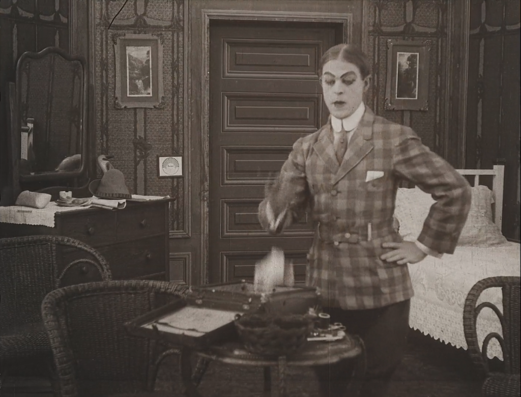 Black and white image of a person in room interacts with case on table in bedroom.