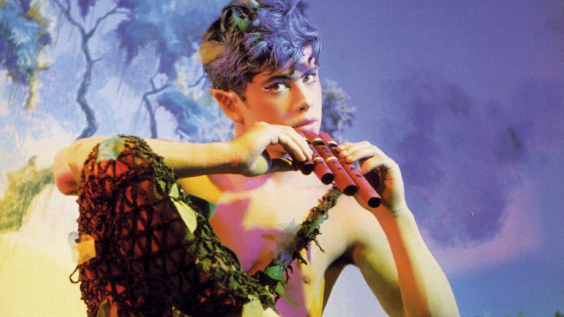 Person looks toward camera holding flute.