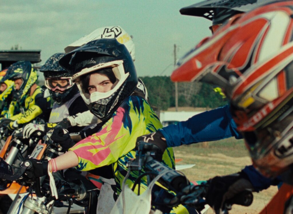 Person on motorbike looks across at another rider.