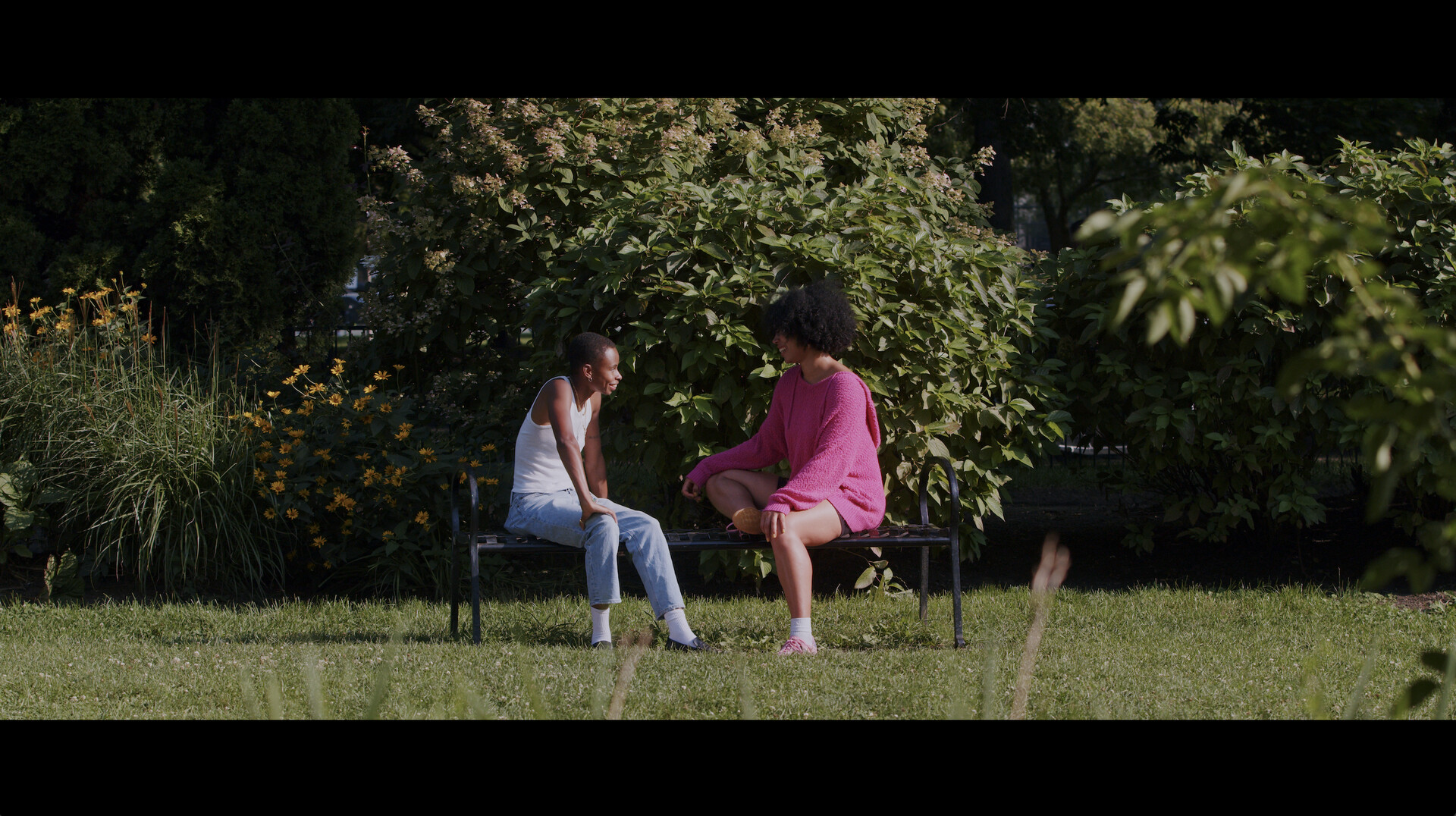 the-last-goodbye1 Two people sit in green space outside.