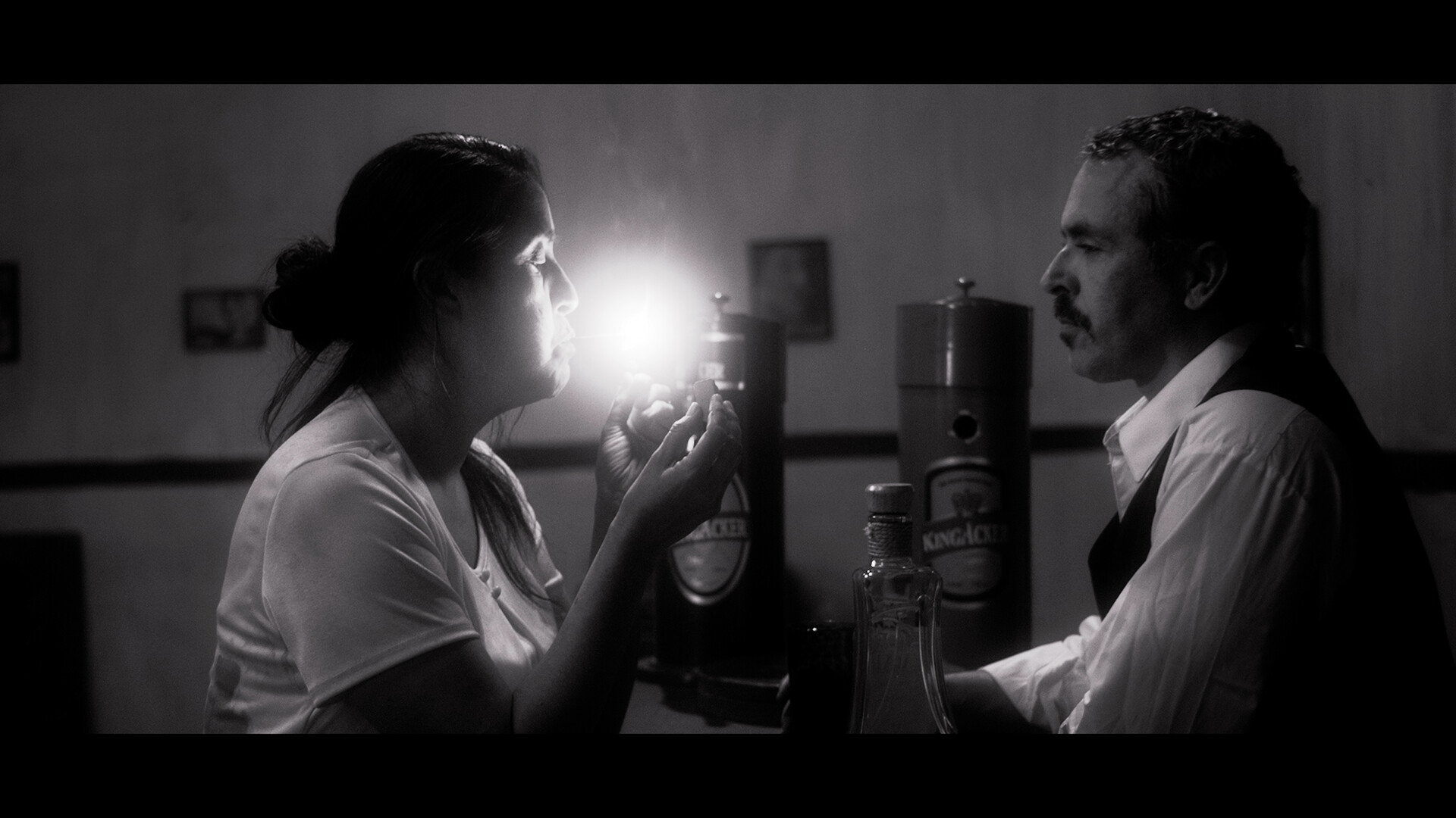 Black and white image of two people looking towards each other.