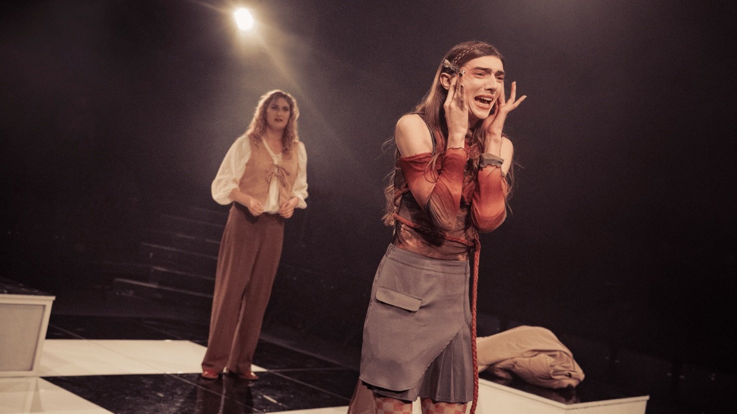 Interior image of performers on stage looking right.